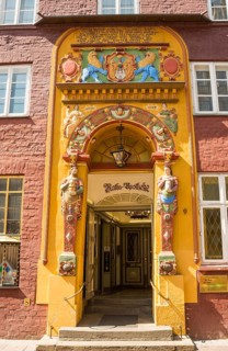 Decorative entrance with coat of arms and figures