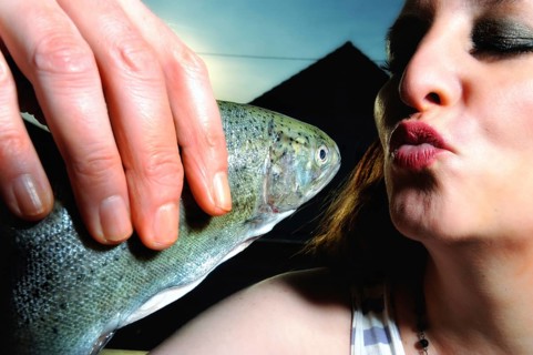 Woman kissing a fish