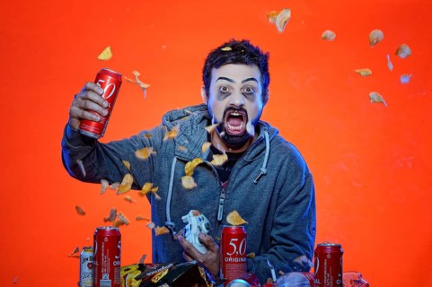 Young man with snacks and gamepad