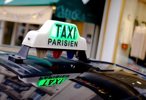 Sign of a Parisian taxi reflected in the roof