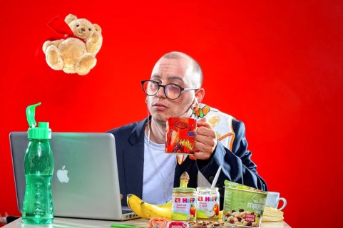 Young man with snacks in front of notebook