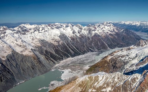 Valley with glacial lake Tasman Lake and glaciated mountain peaks