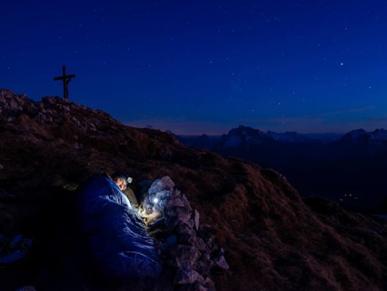 Mountaineer bivouacs at the summit of the Berchtesgadener Hochthron