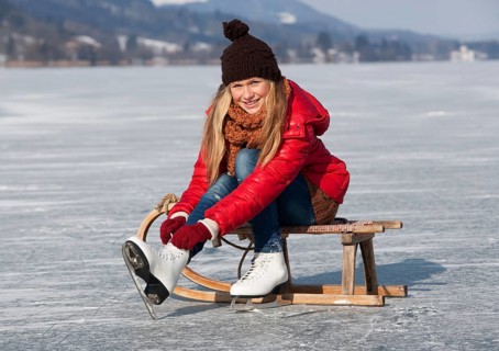 Young girl ice skating at the lake