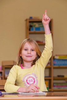 Pupil sitting in a classroom and reporting for class