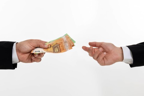 Businessman hands over banknotes