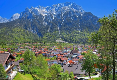View of the town in front of the Karwendel Mountains with Viererspitze