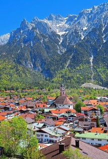 View of the town in front of the Karwendel Mountains with Viererspitze