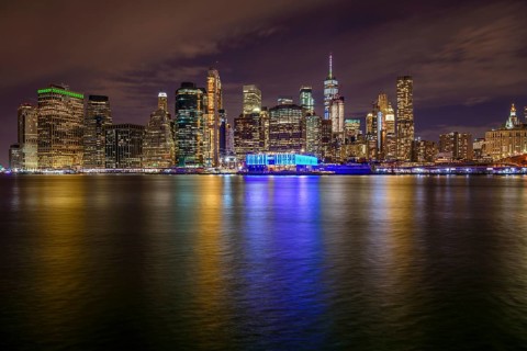 View from Pier 1 at night over the East River to the skyline of lower Manhattan