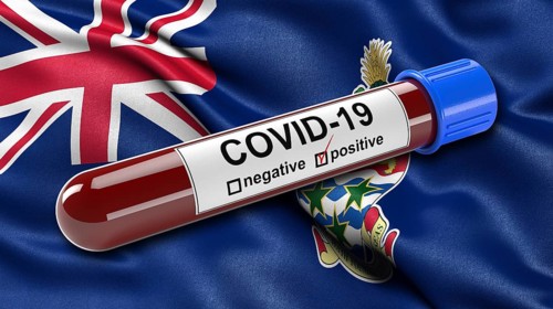 Waving flag of the Cayman Islands with a positive Covid-19 blood test tube