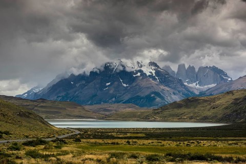 View over Lake Laguna Amarga to the mountain range Cuernos del Paine in clouds