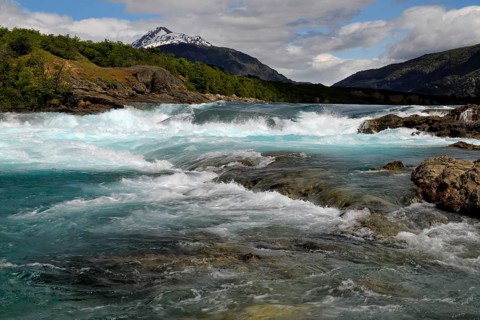 Rapids at the confluence of blue Baker river and grey Neff river