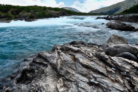 Rapids at the confluence of blue Baker river and grey Neff river