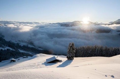 View of the Brixen Valley with morning sun and high fog in winter