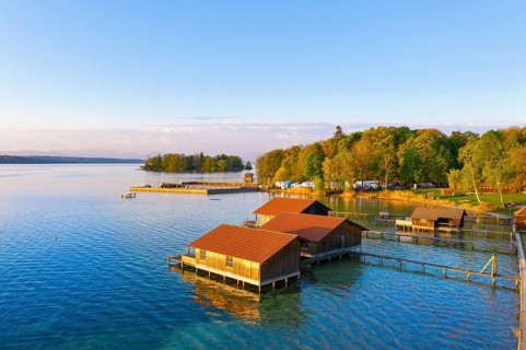 Boathouses and Rose Island in Lake Starnberg near Feldafing in the morning light