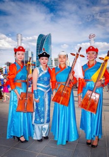 Mongolian girls wearing traditional costume and posing with national music instrument Morin huur