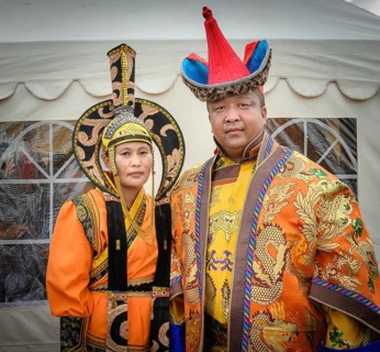 Mongolian family is posing wearing traditional costume in the DEEL