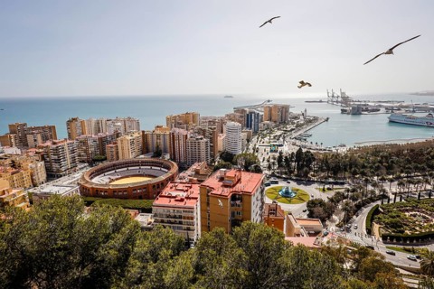 Bullfighting arena and the new harbour district with promenade Muelle Uno