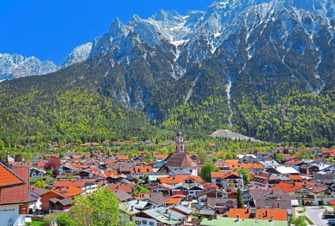 View of the town in front of the Karwendel Mountains with Viererspitze
