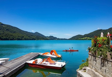 Pedal boats at the landing stage on the lake promenade