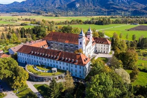 Aerial view of Schlehdorf Monastery with St. Tertulin Parish Church at Lake Lake Kochel