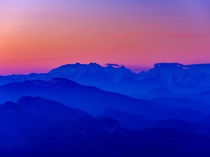 Blue mountain silhouettes at sunrise