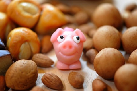 Pink marzipan pig with almonds
