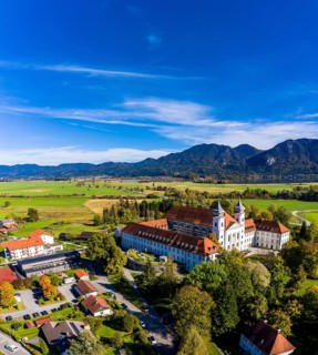 Aerial view of Schlehdorf Monastery with St. Tertulin Parish Church at Lake Lake Kochel