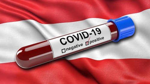 Flag of Austria waving in the wind with a positive Covid-19 blood tube