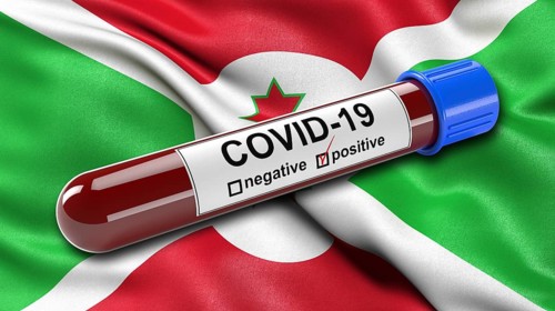 Flag of Burundi waving in the wind with a positive Covid-19 blood tube