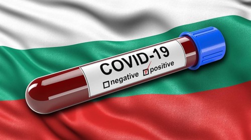 Flag of Bulgaria waving in the wind with a positive Covid-19 blood tube