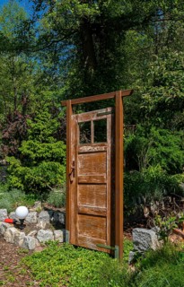 Old brown wooden door as garden decoration