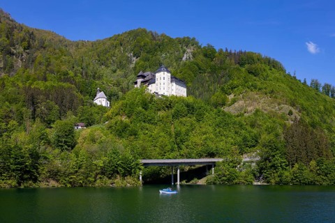 Castle Klaus with mountain church at the Klaus reservoir