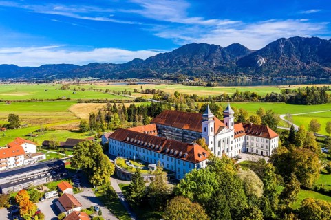 Aerial view of Schlehdorf Monastery with St. Tertulin Parish Church at Lake Lake Kochel