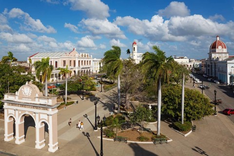Porticoed Neoclassical buildings frame the Parque Jose Marti