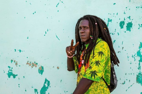 Rasta at a decayed wall of crumbling plaster