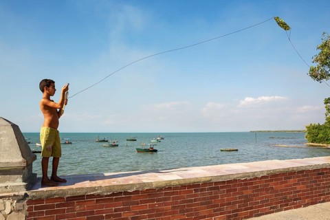 Boy playing with a kite at the Malecon of Manzanillo