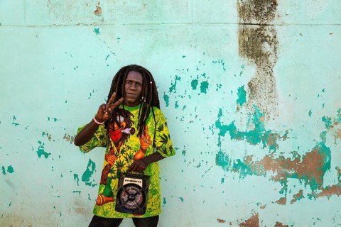 Rasta at a decayed wall of crumbling plaster