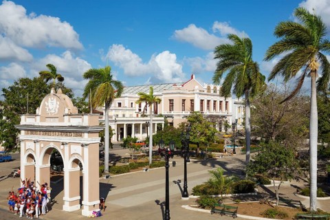 Porticoed Neoclassical buildings frame the Parque Jose Marti