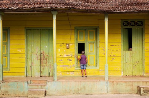 Woman at an old wooden house