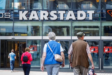 Passers-by in front of the entrance of the Galeria Karstadt Kaufhof store in the Limbecker Platz shopping centre