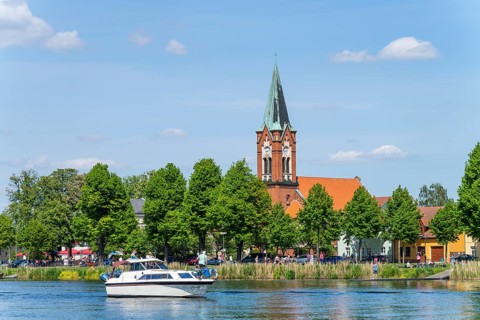 Motorboat on the Havel in front of the island church Maria Meeresstern