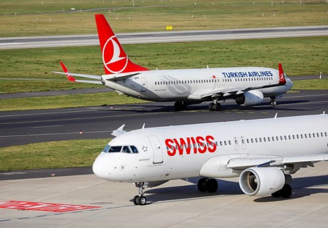 Swiss Airbus A320-214 and Turkish Airlines Boing 737-8F2 aircraft awaiting departure at Duesseldorf International Airport