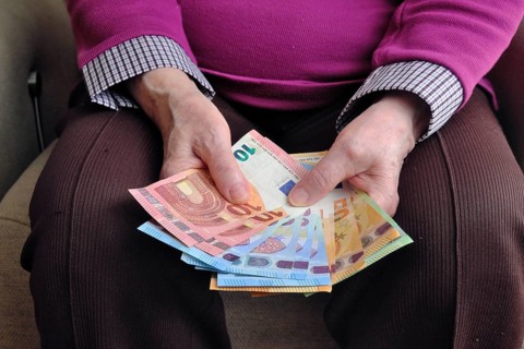 Hand of a senior citizen with euro notes