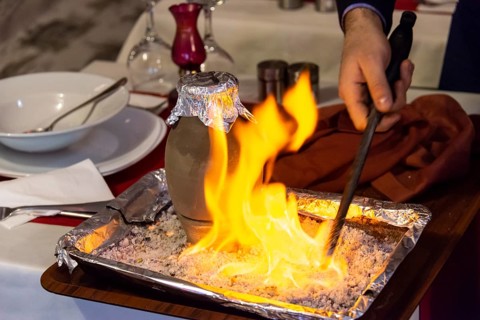 Testi Kebab is served with fire in a restaurant