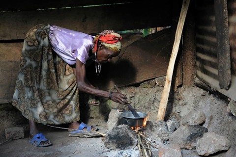 Woman preparing coffee over fire