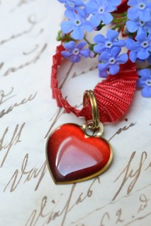 Pendant with heart and forget-me-not on letter paper with old writing