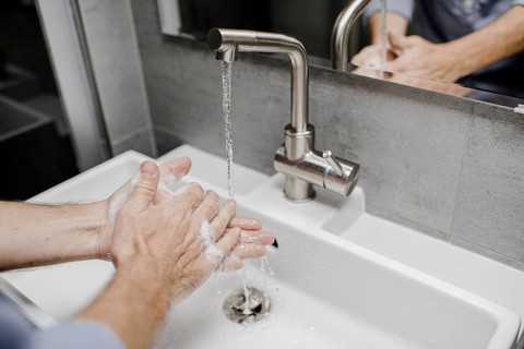 Man washing his hands at the sink