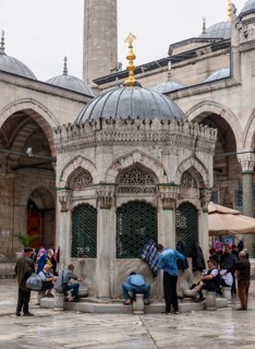 Men washing themselves at the cleaning fountain