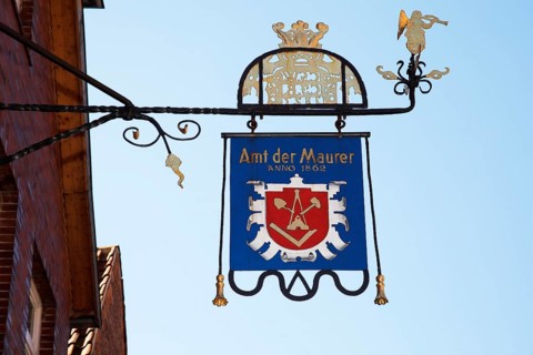 Craftsman's sign Amt der Maurer Anno 1862 on a building in the old town